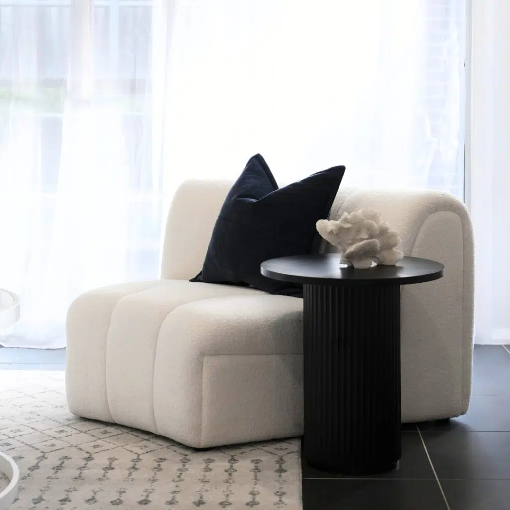 Juno Side Table with wood finish next to modern white sofa