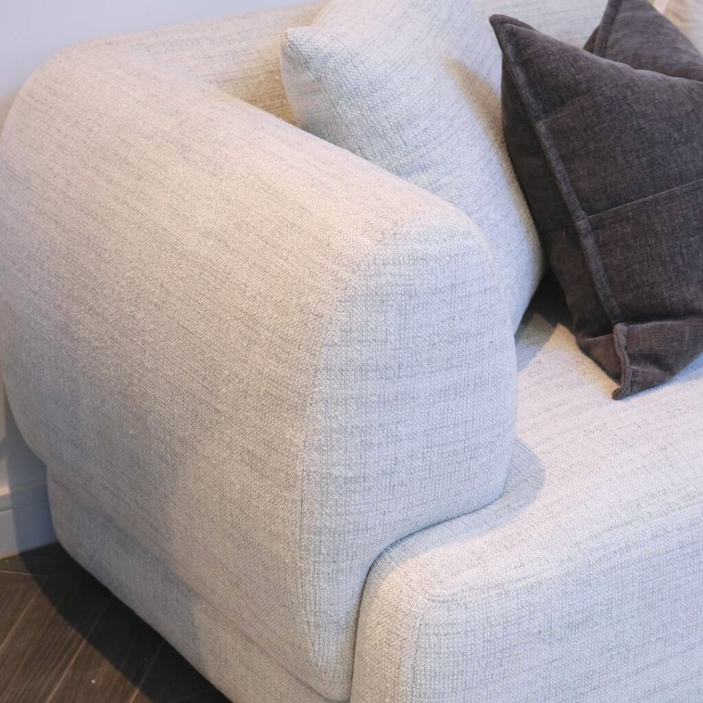 Neutral fabric Luna 3-Seater Sofa with decorative cushions in a lounge setting