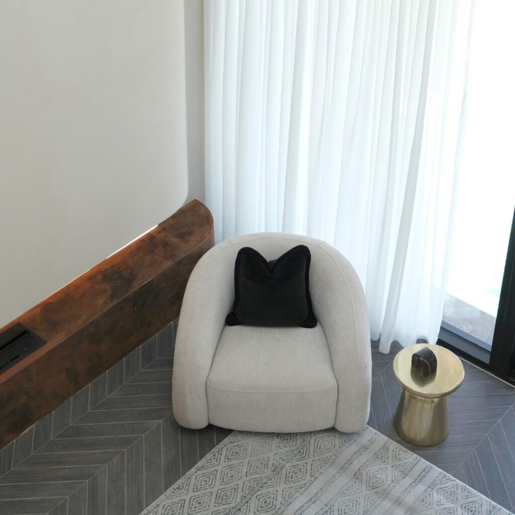 Mira Armchair creating a cozy reading corner in a modern lounge