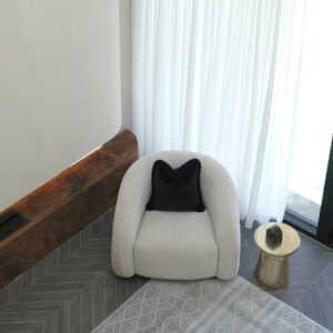 Mira Armchair creating a cozy reading corner in a modern lounge