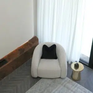 Mira Armchair creating a cozy reading corner in a modern lounge