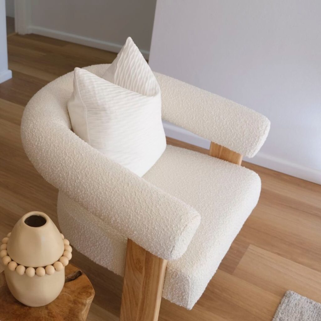 Compact side table next to an armchair creating a cozy reading nook