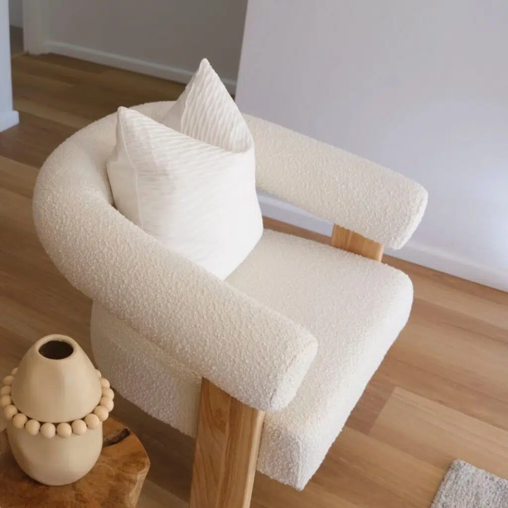 Compact side table next to an armchair creating a cozy reading nook