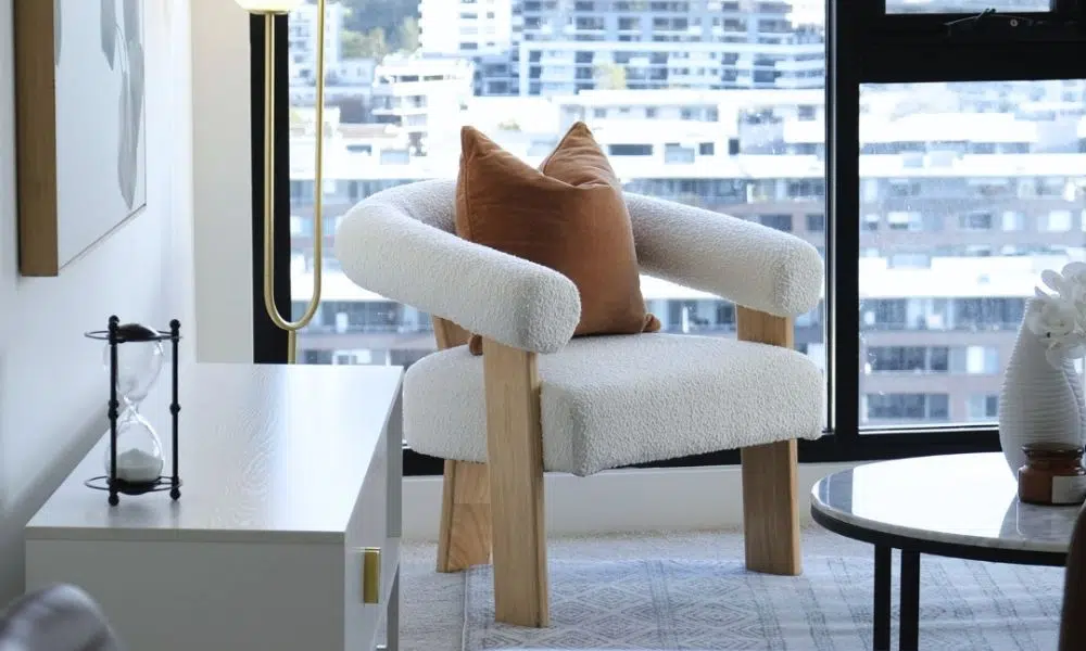 Compact side table next to an armchair creating a cozy reading nook