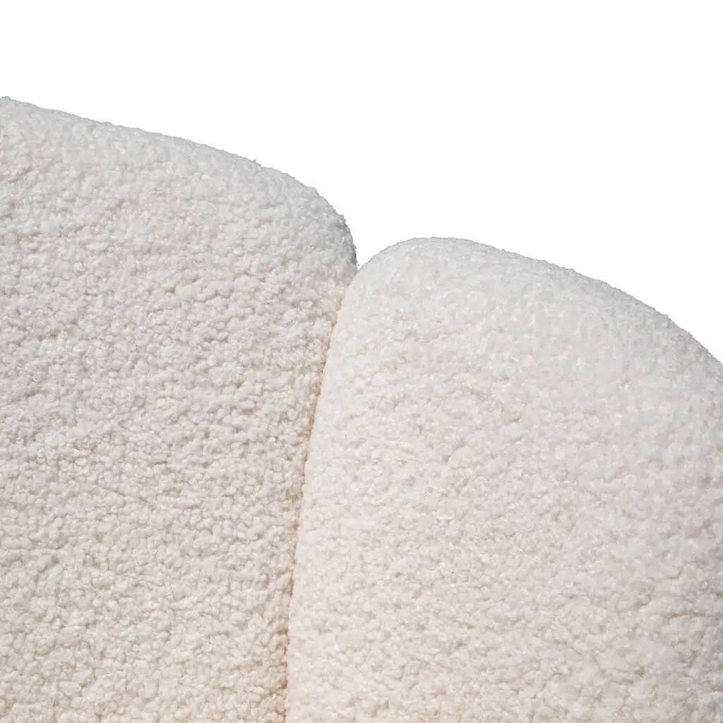 Elegant white lounge chair with brass base, modern design, plush upholstery, perfect for living spaces.