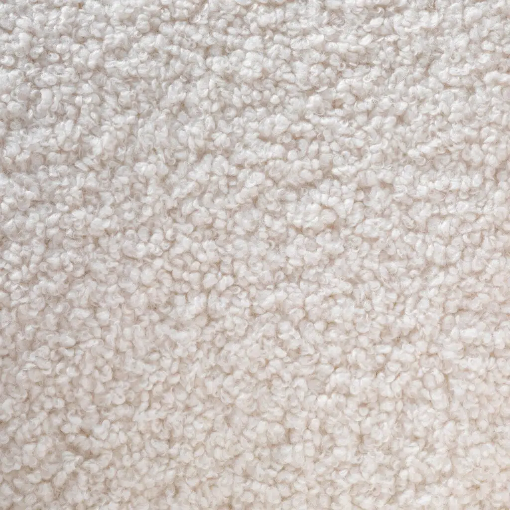 Elegant white lounge chair with brass base, modern design, plush upholstery, perfect for living spaces.