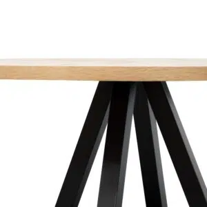 Round oak dining table with black metal legs