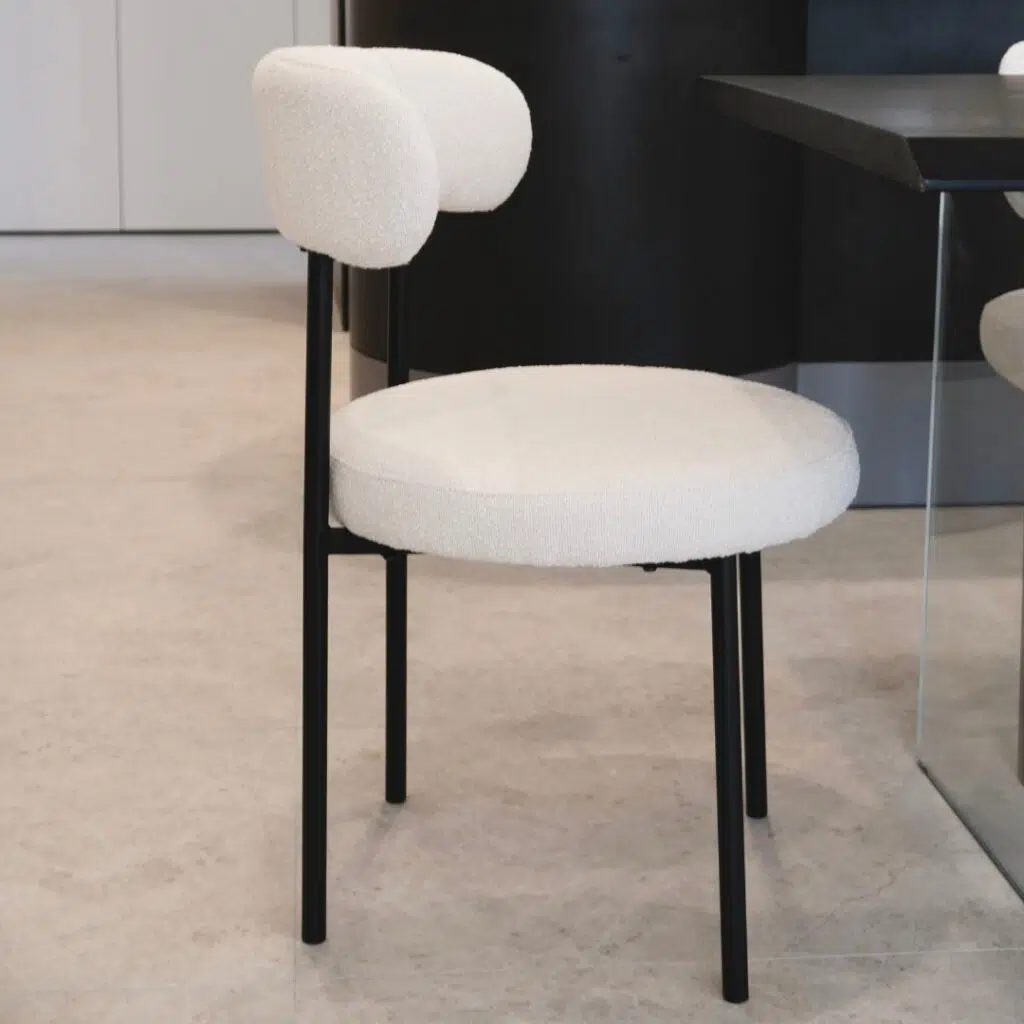 Arco boucle dining chair in cream fabric with modern design and sturdy metal frame