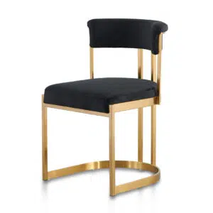 Luna black velvet dining chair with golden base, sleek silhouette, and U-shaped leg.