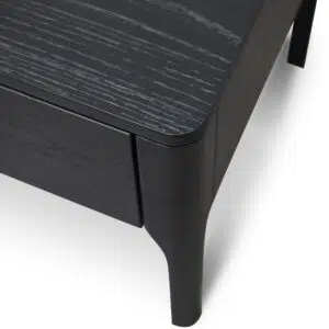 Modern black veneer bedside table with brass handle, ideal for minimalist bedrooms.