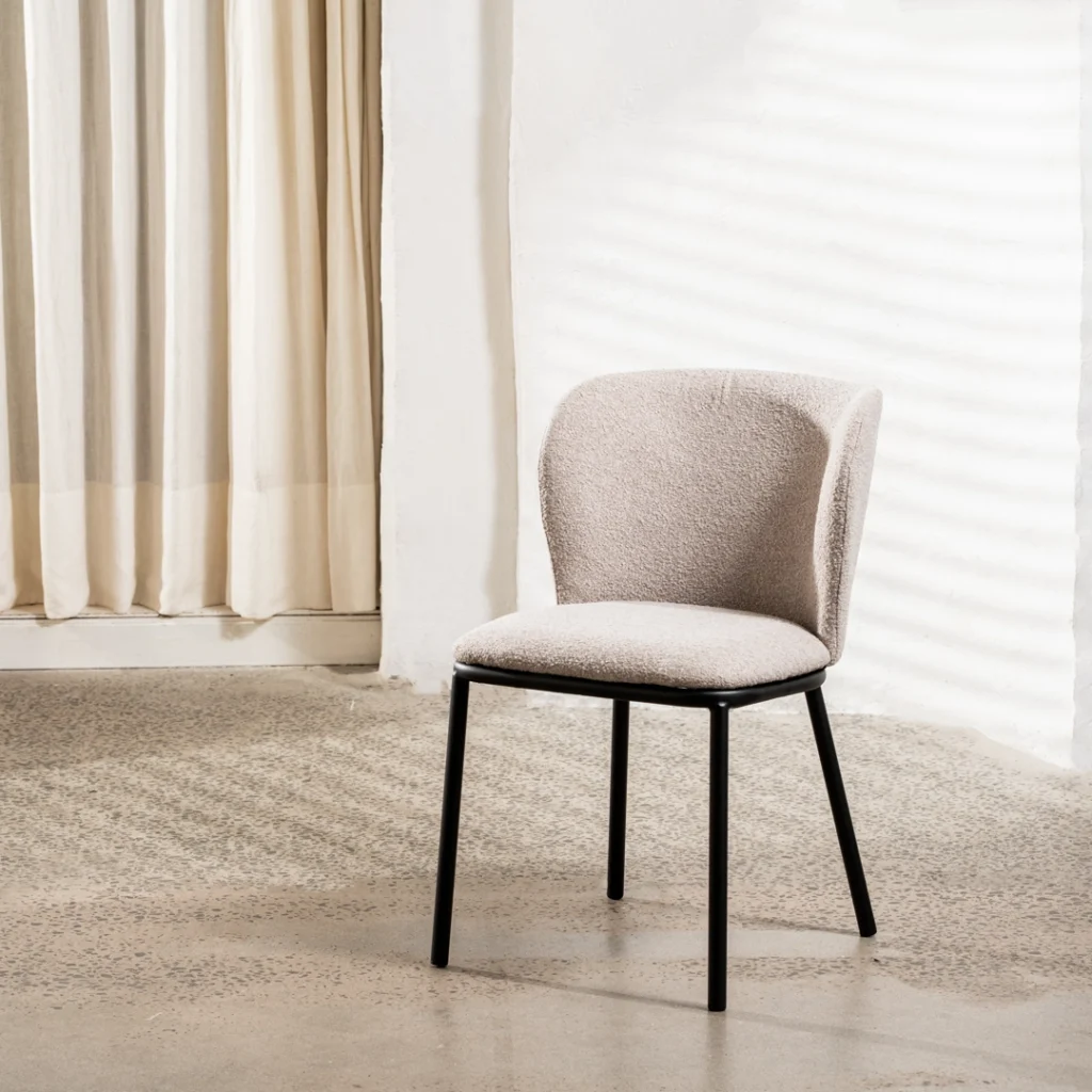 Modern latte boucle dining chairs with black metal frame and textured upholstery for versatile spaces