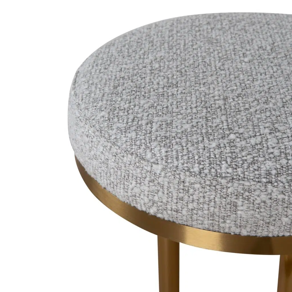 Brushed gold bar stool with silver grey boucle upholstery and ergonomic design