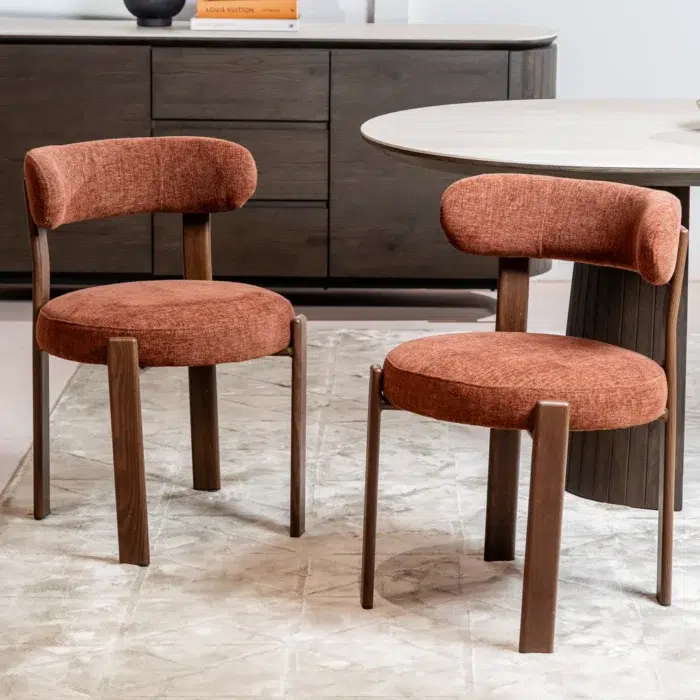 Carmo dining chair in rust color featuring boucle fabric and walnut legs for modern interiors