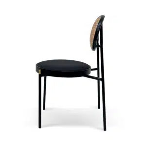 Black dining chair with gold accents and natural rattan backrest for modern interiors