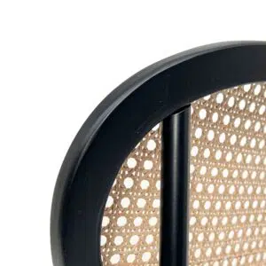 Black dining chair with gold accents and natural rattan backrest for modern interiors