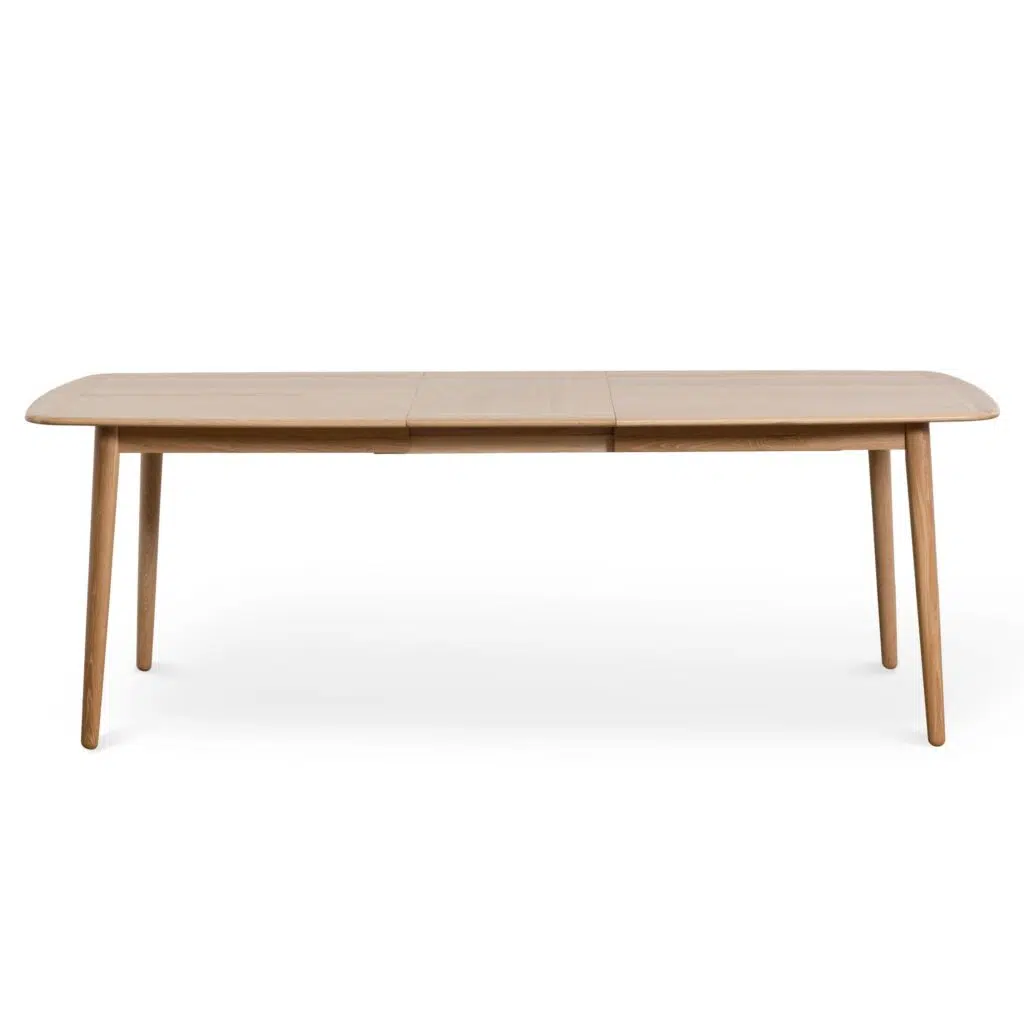 Natural wood poppy extendable dining table with tapered legs and soft edges for modern interiors