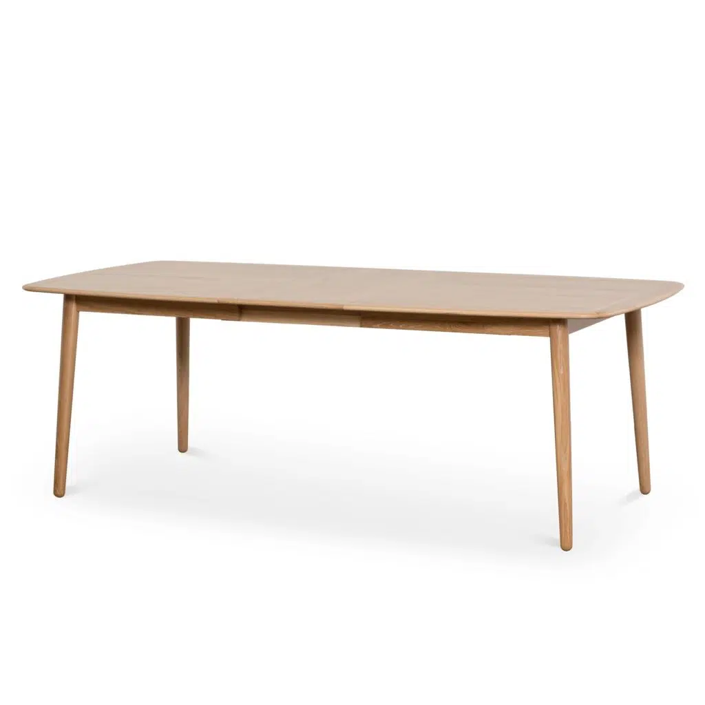 Natural wood poppy extendable dining table with tapered base and soft edges for modern homes