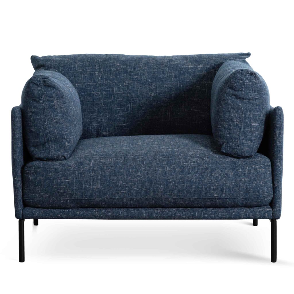 Dark blue fabric armchair with padded silhouette and tapered black metal legs for modern interiors