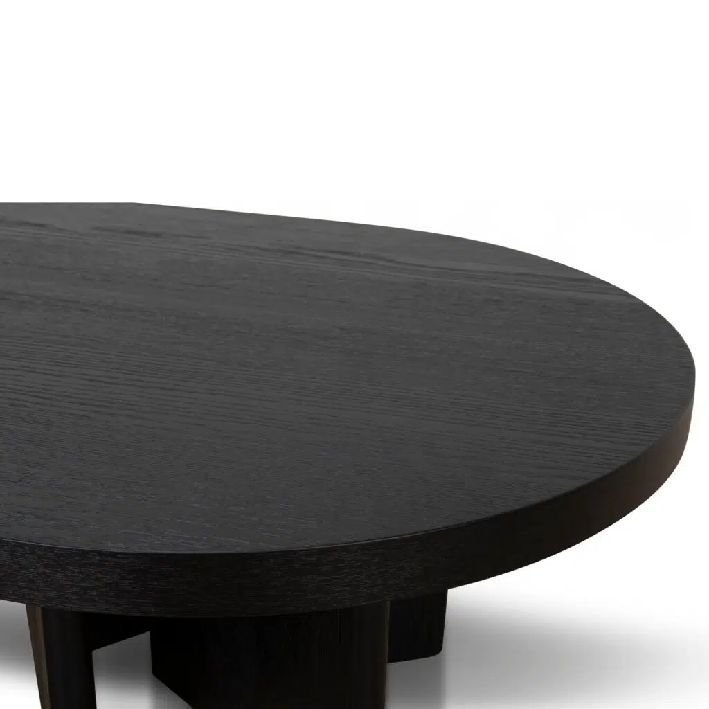 Modern pill-shaped coffee table with textured espresso black finish and open-triangle legs for living room.