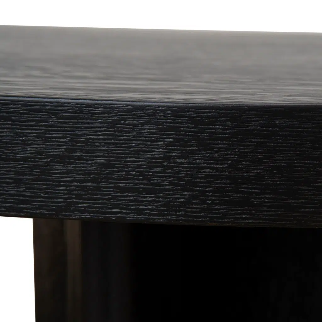 Modern pill-shaped coffee table with textured espresso black finish and open-triangle legs