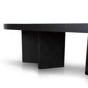 Modern pill-shaped coffee table with textured espresso black finish and triangular legs.