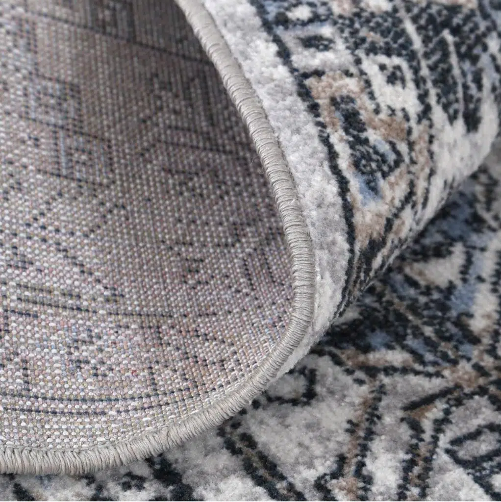 Traditional blue-grey polyester rug with distressed texture and versatile design for modern interiors.