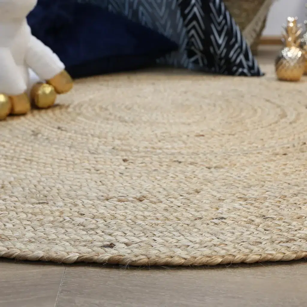 Natural jute round rug handwoven by artisans perfect for high traffic areas adding rustic charm and eco friendly style to any home