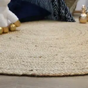 Natural jute round rug handwoven by artisans perfect for high traffic areas adding rustic charm and eco friendly style to any home