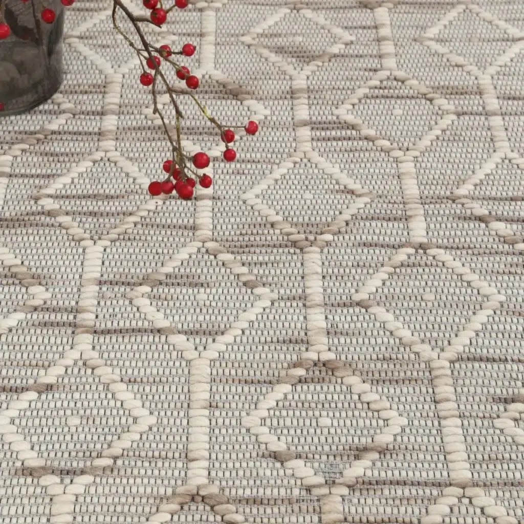 Hand loomed Copacabana beige wool rug with loop pile texture adds sophistication to any room
