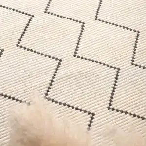 Handcrafted zig-zag wool blend cream rug softens home decor with timeless design and durability